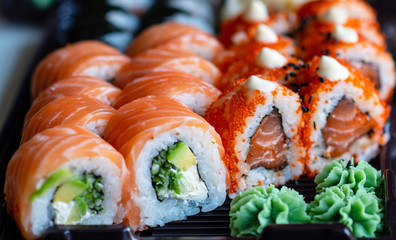 sushi with salmon and green wasabi sauce. takeaway food