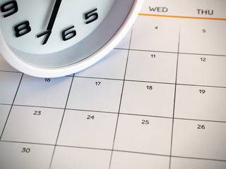 The white clock put on calendar.  
