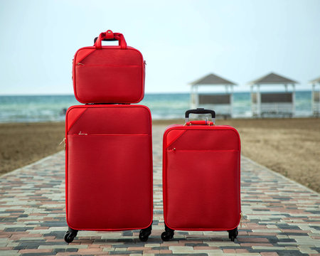 set of red suitcases and bags