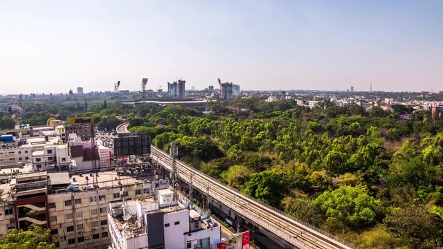 Elevated metro line above MG Road in front of M Chinnaswamy Stadium in Bangalore downtown time lapse