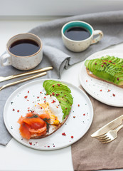 Bruschetta with sliced avocado, poached egg and salted salmon.