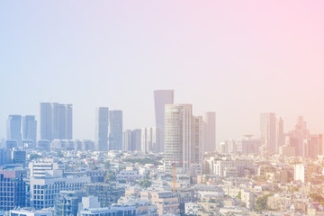 Obraz premium Cityscape, modern building on a blue background. City blurred lights background after sunset. Morning view of the business center of Tel Aviv, Israel. Modern city. 