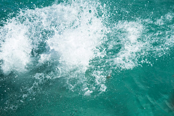 Huge splashing water in the sea from people falling into water, abstract art picture for background.