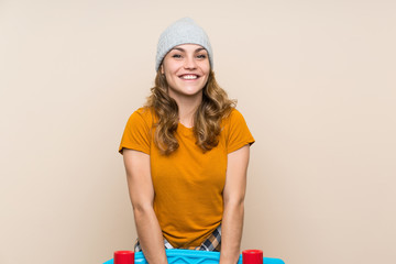 Young skater blonde girl over isolated background