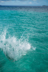 Fototapeta premium Huge splashing water in the sea from people falling into water, abstract art picture for background.