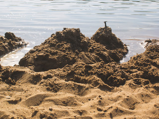 children's buildings made of sand on the river Bank, Russia.