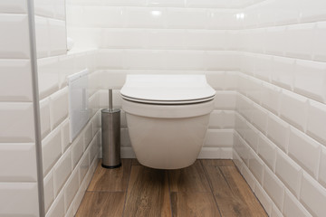Fototapeta na wymiar Modern toilet or WC in clean apartment or flat with white porcelain