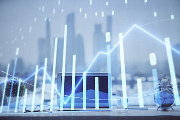 Forex graph hologram on table with computer background. Multi exposure. Concept of financial markets.