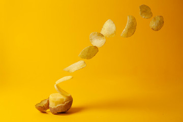 potato chips fly on a yellow background, the process of making chips, fast food levitation