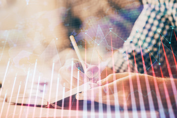 Multi exposure of two men planing investment with stock market forex chart.