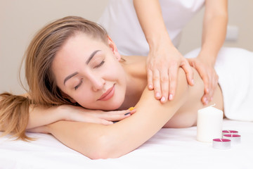 Fototapeta na wymiar Massage and body care. Spa body massage woman hands treatment. Woman having massage in the spa salon for beautiful girl