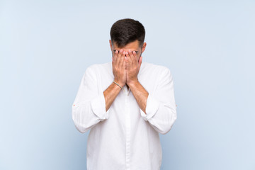 Handsome man with beard over isolated blue background with tired and sick expression