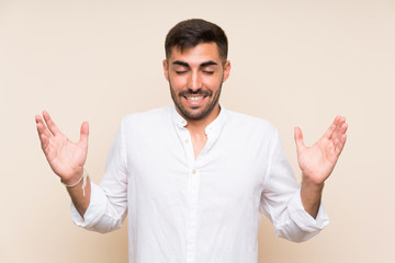 Fototapeta premium Handsome man with beard over isolated background laughing