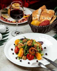 salad with walnuts, tomatoes, oranges and shrimps