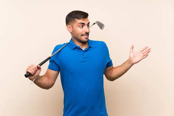 Young handsome golfer man over isolated background with surprise facial expression