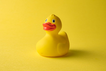 Rubber duck on yellow background minimal creative concept.