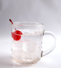 glass with a cocktail and a cherry