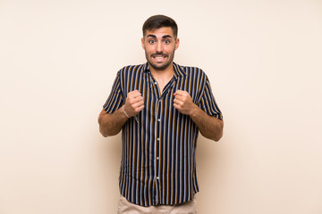 Fototapeta premium Handsome man with beard over isolated background celebrating a victory