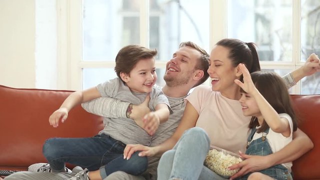 Excited family football fans watching sport tv game celebrating goal