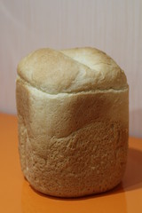a loaf of homemade bread on an orange background