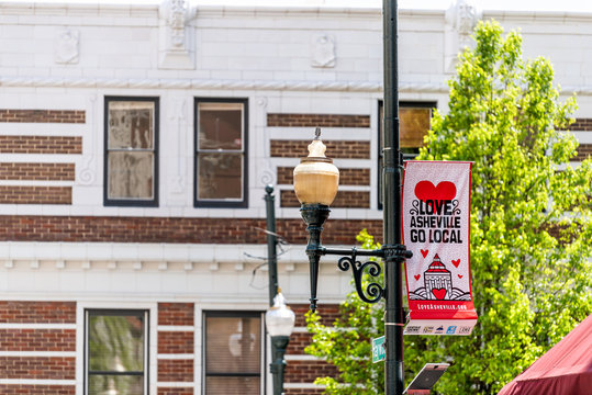 Asheville, USA - April 19, 2018: Downtown Old Town Street In North Carolina NC City With Sign For Local Love Banner On Lamp Post