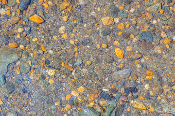 Multicolored stones underwater, background, texture.