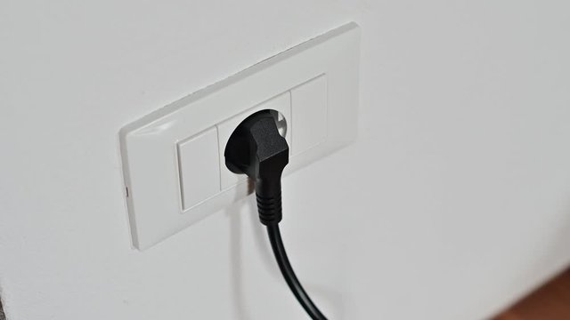 cabel being pluged in and out of a plug