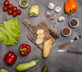 Healthy food clean eating selection of raw vegetables with a board on a dark background. Top view