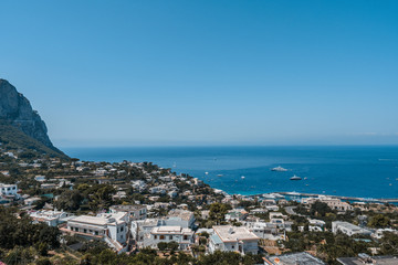 Capri city on Capri Island with Tyrrhenian sea with boats in summer time