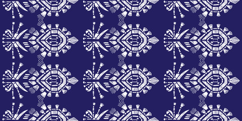 Drapery ikat navajo motif etnic white tribal ornamentalpattern on blue background. Surface background design for cotton fashion. Textile fabric ornament future rug.