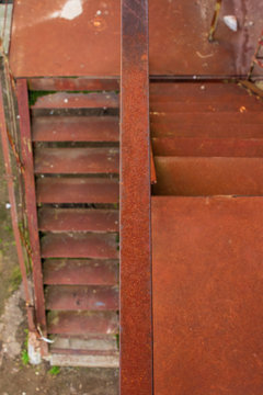 metal stairs. abandoned urban background full of rusty texture. view downside