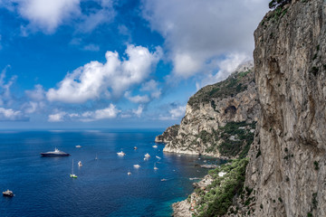 Fototapeta na wymiar Crag cliff by Tyrrhenian sea in summer with dramatic couds, view from Garden of Augustus, Capri
