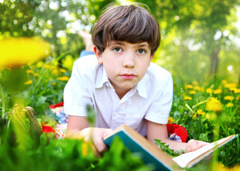 teenager boy reading book outdoor spring