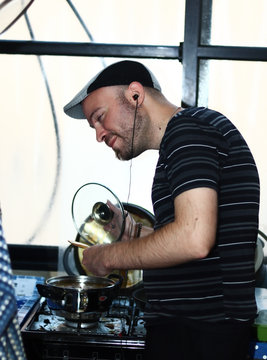 A friend dressed as a Gopnik (Russian street thug) making a soup.