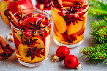 Apple cider mulled wine hot toddy or christmas punch in glass with fruits and spices