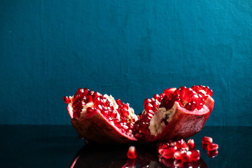 Juicy ripe red grenades on a dark background. Organic and benefit garnet fruit.