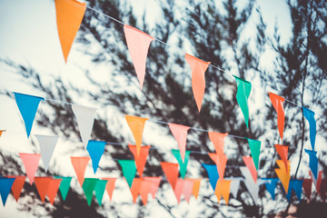 Colorful paper bunting party flags isolated on white background  . Carnival garland with flags. Decorative colorful party pennants for birthday celebration, festival and fair decoration. Holiday