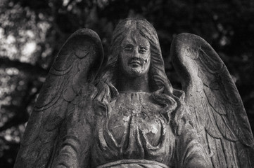 Old photo of the angel monument with children. Black and white photo.