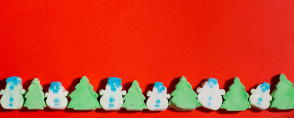 Christmas marshmallows sweets on a red background