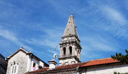 the ancient temple , the bell tower with a wall clock, Perast, Montenegro