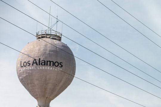 Los Alamos, USA - June 17, 2019: City In New Mexico With View Of Water Tower Tank On Road With Sign For National Laboratory