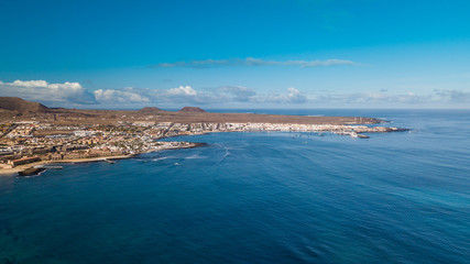 Fototapeta na wymiar aerial view of waves crashing on the bay of corralejo, fuerteventura