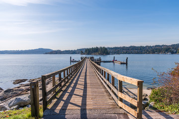 View over inlet, ocean and island with boat and mountains in beautiful British Columbia. Canada.