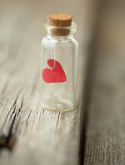 red heart in the glass is closed. Day greetings card. Valentines theme. Selective focus. Copy space.