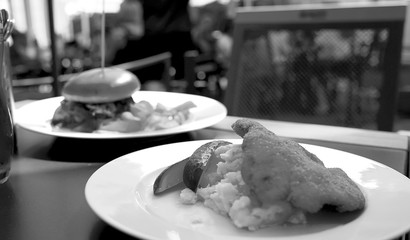 meat chop with boiled potatoes and pickles on a plate in a restaurant