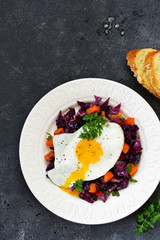 Fried eggs with warm salad of red cabbage and pumpkin.