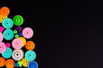 Colorful gears on a black background ,concept of work process movement gears