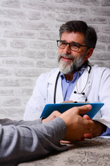 Senior doctor urologist advises a male patient. Mature doctor consults young patient. Doctor...
