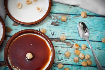 Hazelnuts and caramel on panna cotta seen from above