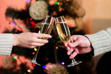 Cheers concept. New year tradition. Merry christmas. Almost midnight. Alcohol drink. Glass filled sparkling wine or champagne. Having nice time. Toast. Glass of champagne. Champagne couple glasses